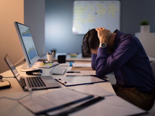 Employee having stress behind his computer